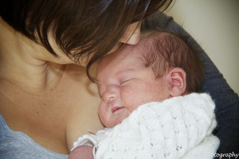 Mummy kissing newborn babies head - newborn baby portrait photography sydney